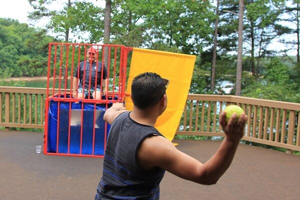 Lake Lanier 2016 (web) man throwing ball at dunk tank